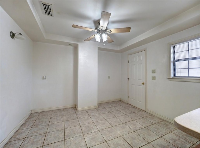 4821 Kosarek Dr, Corpus Christi, TX 78415 - empty room with ceiling fan, a raised ceiling, and light tile patterned floors