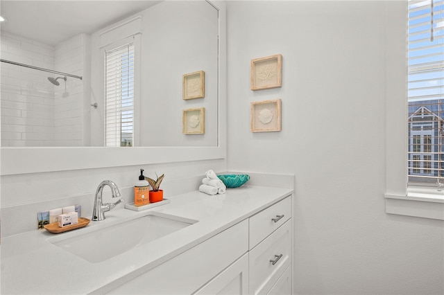 bathroom featuring vanity and a tile shower