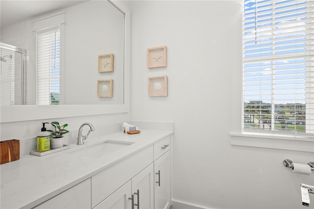 bathroom with an enclosed shower and vanity