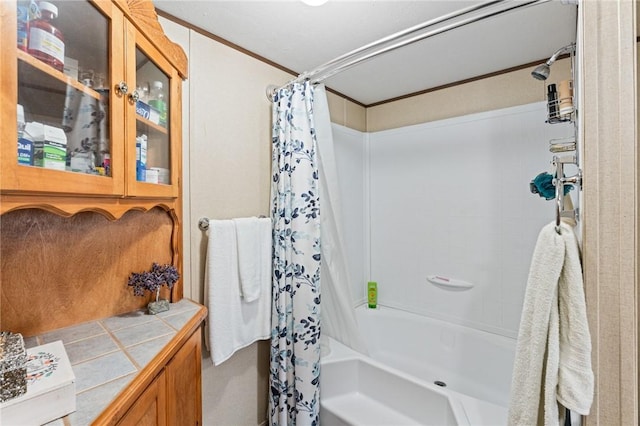 bathroom with crown molding and shower / bath combination with curtain