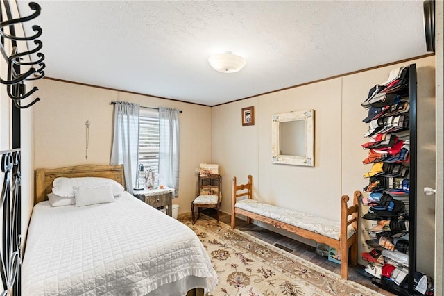 bedroom featuring a textured ceiling and hardwood / wood-style flooring