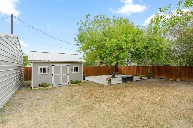 view of yard with a storage unit and a patio area