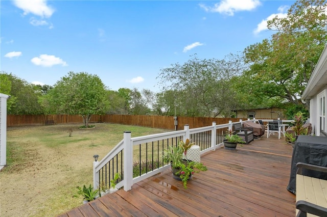 wooden terrace with a lawn