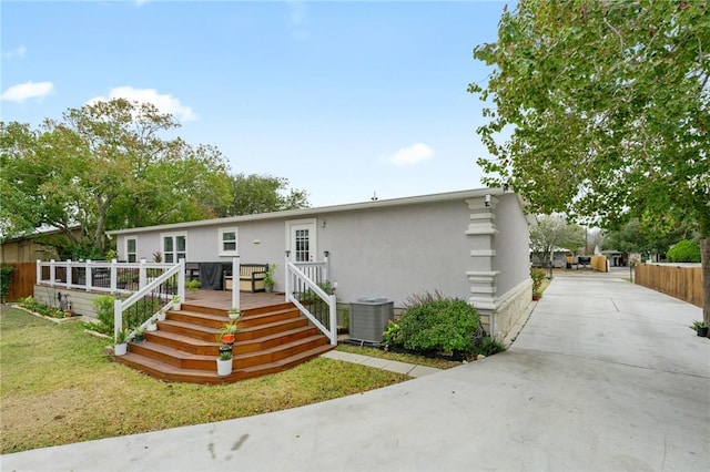 manufactured / mobile home featuring a wooden deck and cooling unit