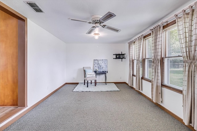 sitting room with carpet and ceiling fan