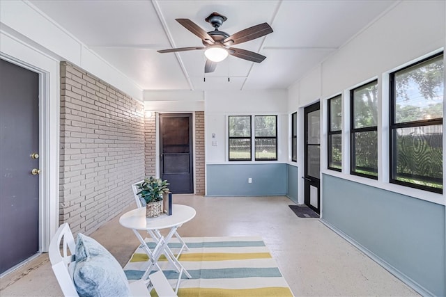 sunroom featuring ceiling fan