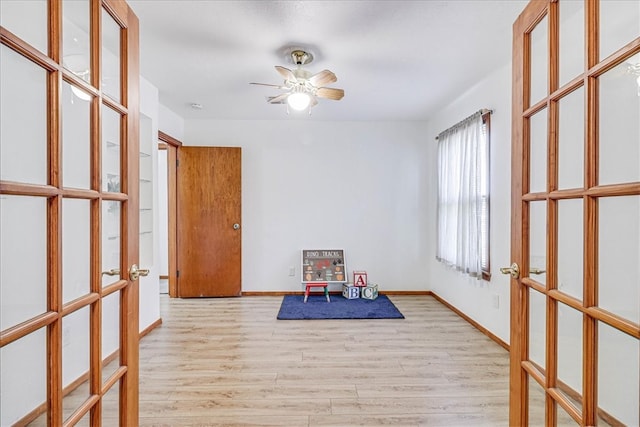 playroom with ceiling fan and light hardwood / wood-style flooring