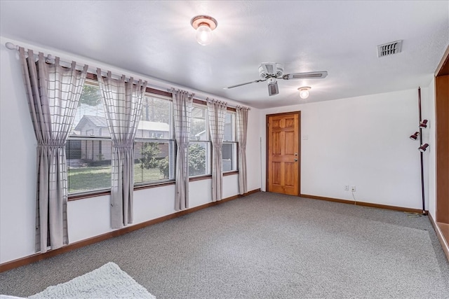 empty room featuring ceiling fan and carpet floors