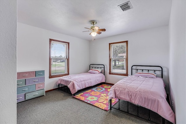 carpeted bedroom with a textured ceiling and ceiling fan