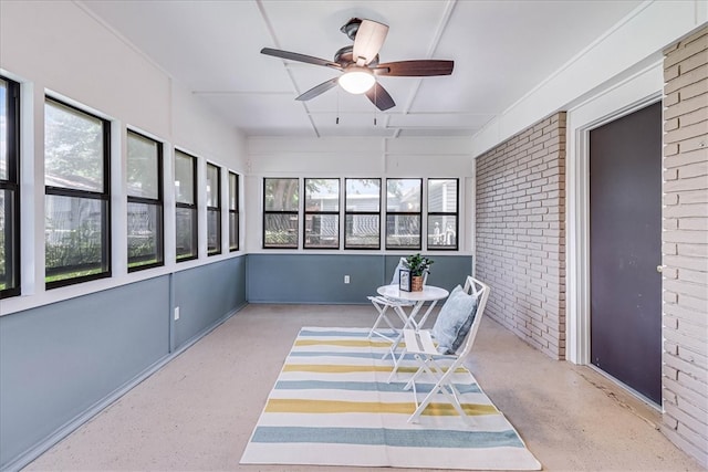 sunroom / solarium with a healthy amount of sunlight and ceiling fan