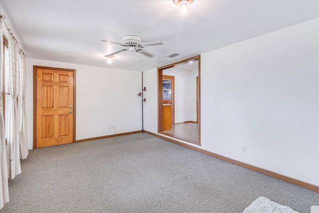 carpeted empty room featuring ceiling fan