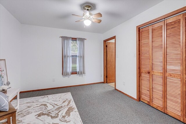 unfurnished bedroom featuring light colored carpet, ceiling fan, and a closet