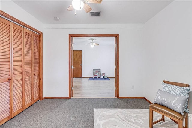 living area featuring ceiling fan and carpet floors