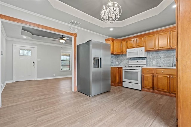 4446 Naples St, Corpus Christi, TX 78415 - kitchen with white appliances, a raised ceiling, light countertops, light wood-style floors, and a chandelier