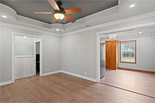 4446 Naples St, Corpus Christi, TX 78415 - unfurnished room featuring a tray ceiling, ornamental molding, wood finished floors, ceiling fan, and a chandelier