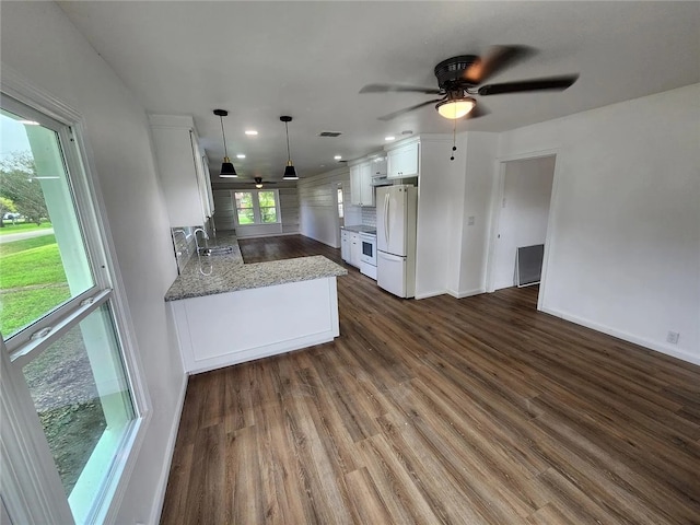 kitchen featuring sink, hanging light fixtures, dark hardwood / wood-style floors, white appliances, and white cabinets