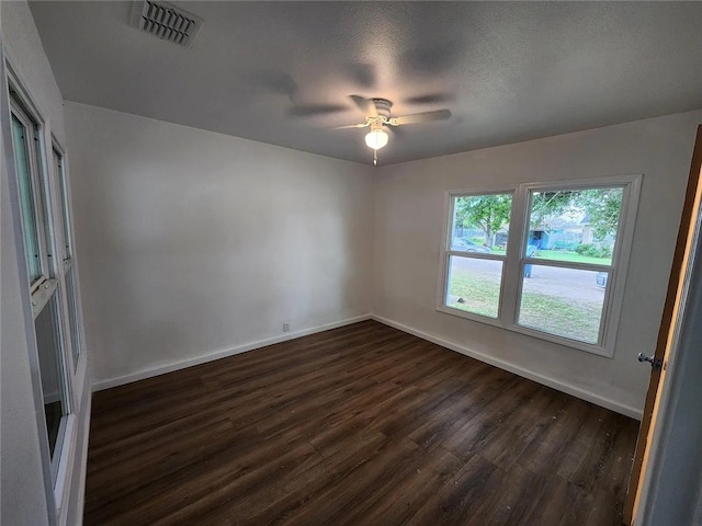 unfurnished room featuring a textured ceiling, ceiling fan, and dark hardwood / wood-style floors