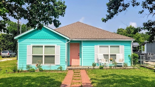 bungalow-style home with a front lawn