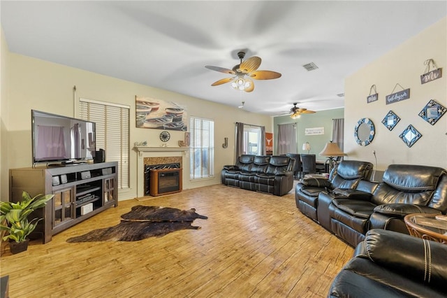 living room with ceiling fan and light hardwood / wood-style flooring