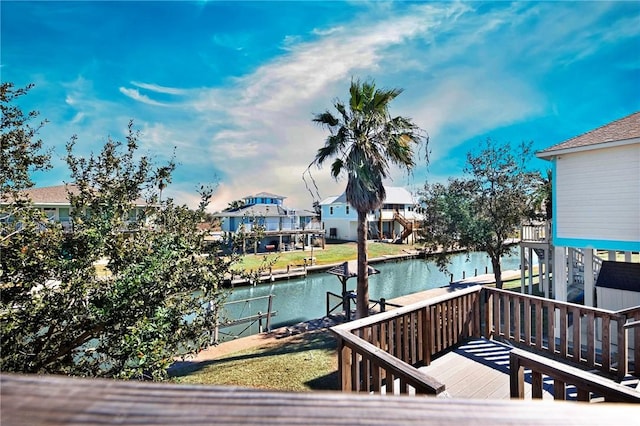 wooden deck with a water view and a dock