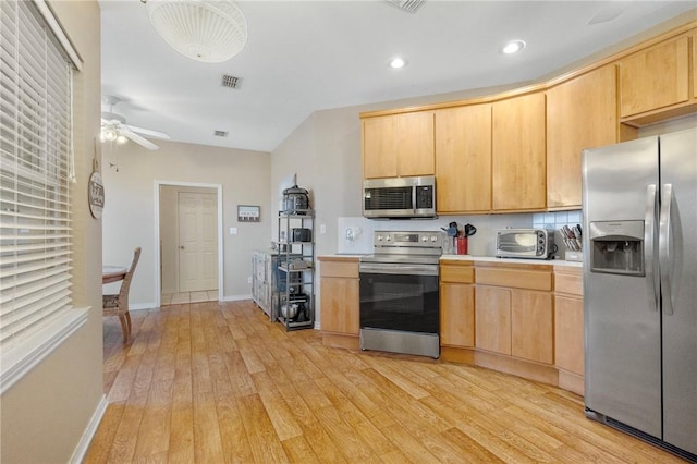 kitchen featuring light brown cabinets, stainless steel appliances, light hardwood / wood-style flooring, and ceiling fan