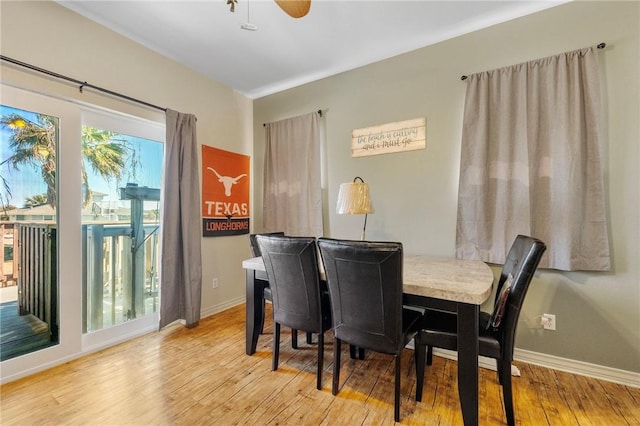 dining room with light hardwood / wood-style floors and ceiling fan