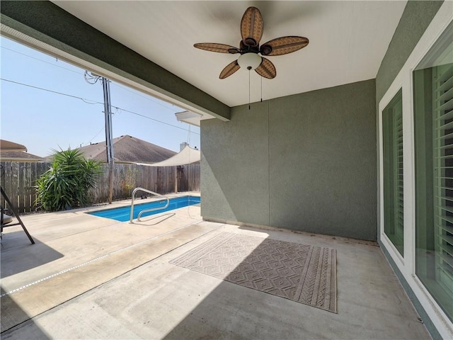 view of patio featuring a fenced in pool, a fenced backyard, and a ceiling fan