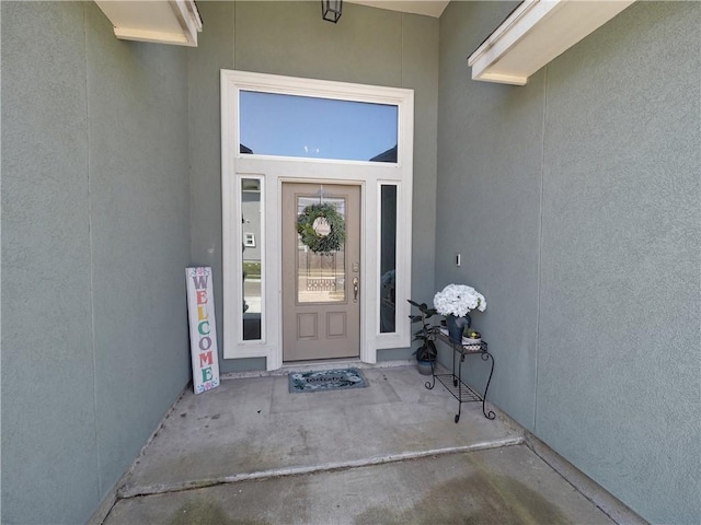 doorway to property with stucco siding