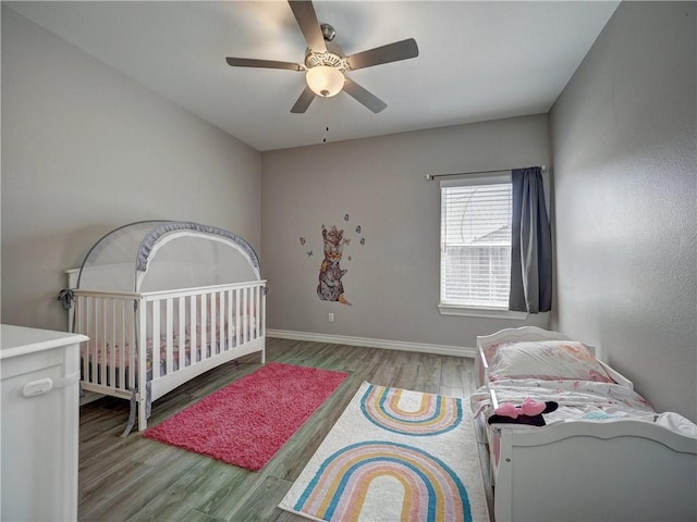 bedroom featuring ceiling fan, baseboards, and wood finished floors