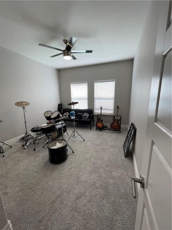 miscellaneous room with carpet flooring, baseboards, and ceiling fan