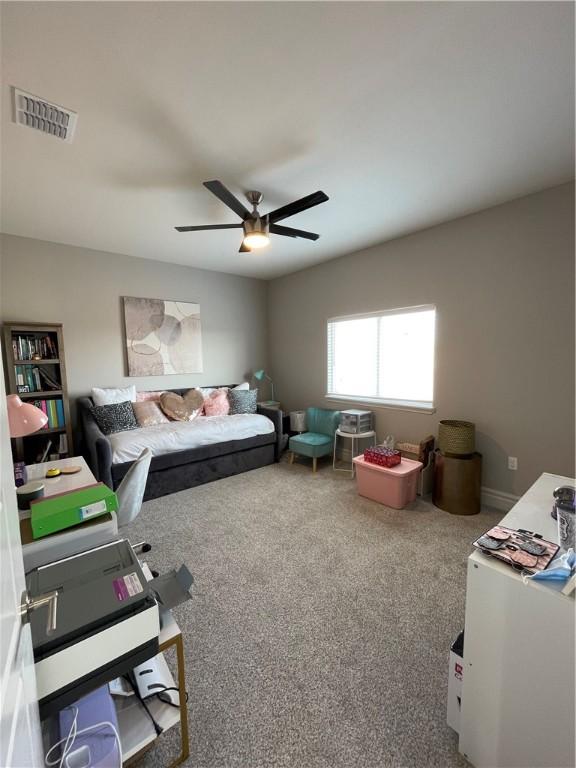 carpeted bedroom featuring visible vents and ceiling fan