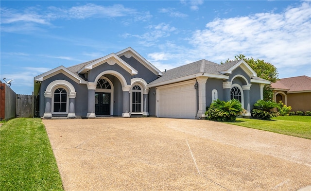 8245 Rock Crest Dr, Corpus Christi, TX 78414 - single story home with an attached garage, driveway, stucco siding, and french doors