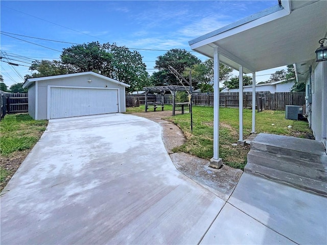 6042 Hugo Dr, Corpus Christi, TX 78412 - view of yard with an outdoor structure, a detached garage, and central air condition unit