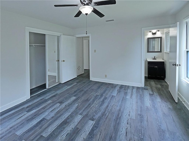 6042 Hugo Dr, Corpus Christi, TX 78412 - unfurnished bedroom featuring dark wood-style floors, a sink, baseboards, and a ceiling fan