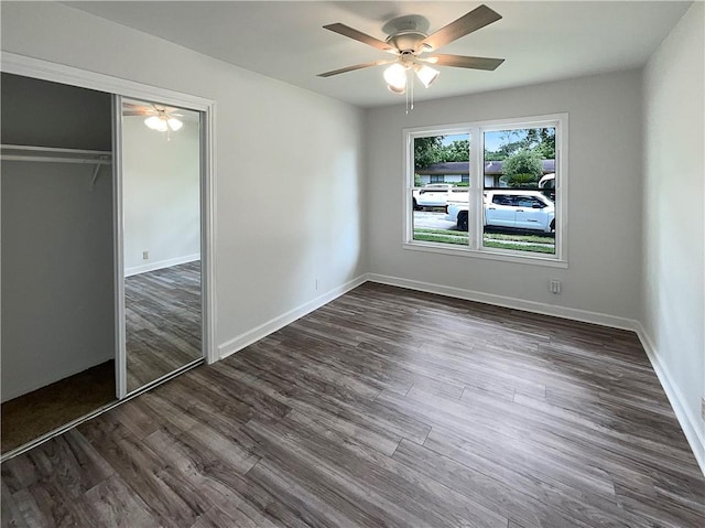 6042 Hugo Dr, Corpus Christi, TX 78412 - unfurnished bedroom with a closet, dark wood-style floors, ceiling fan, and baseboards