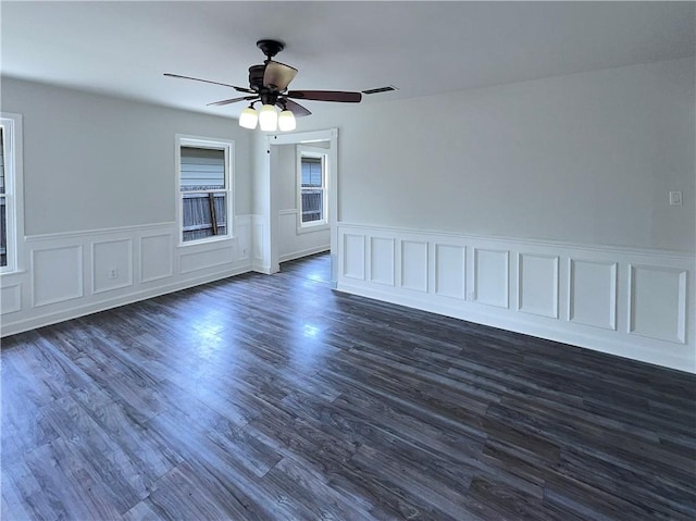 6042 Hugo Dr, Corpus Christi, TX 78412 - empty room featuring wainscoting, a ceiling fan, and dark wood finished floors