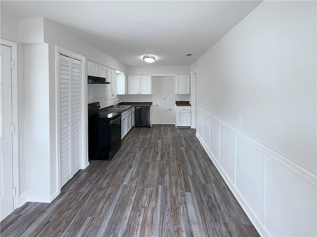 6042 Hugo Dr, Corpus Christi, TX 78412 - kitchen with black appliances, a sink, under cabinet range hood, dark countertops, and white cabinets