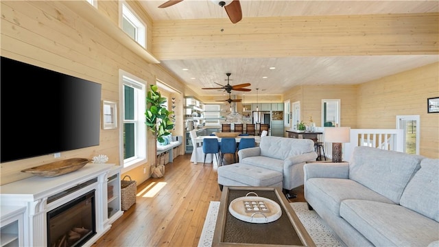 living room with wooden walls, light hardwood / wood-style flooring, and wooden ceiling