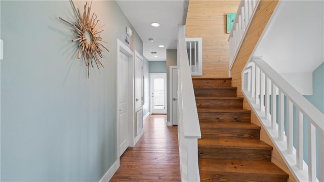 staircase with wood-type flooring