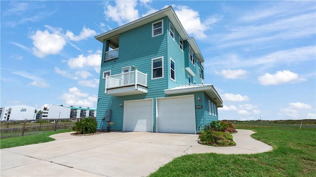 view of home's exterior featuring a yard, a balcony, and a garage