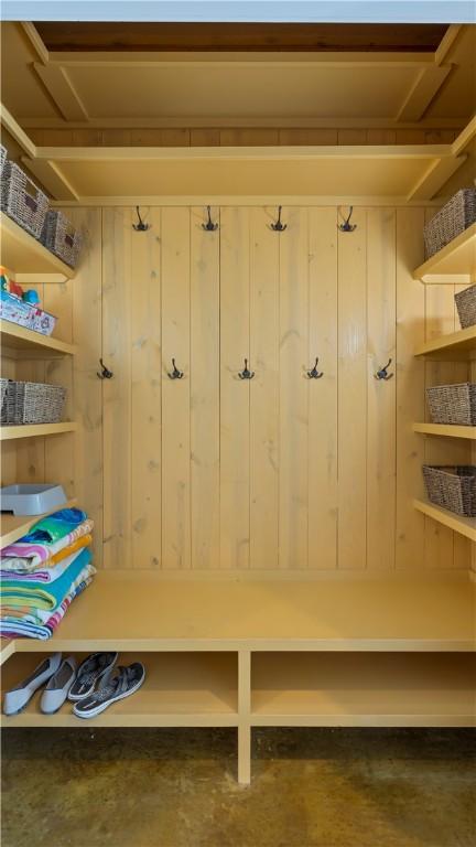 mudroom featuring wood walls