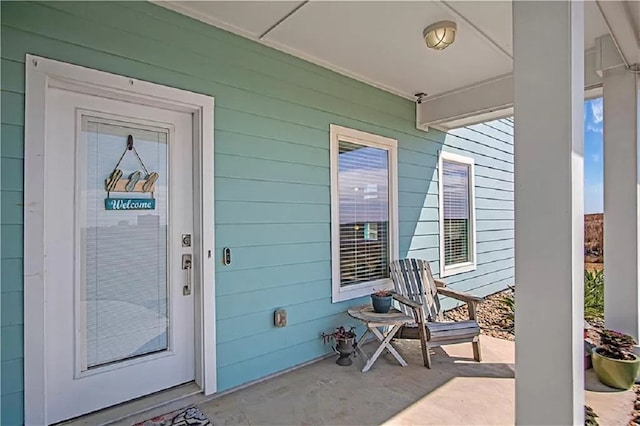 view of exterior entry with covered porch