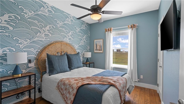 bedroom with ceiling fan and wood-type flooring