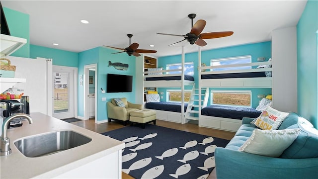 interior space with ceiling fan, sink, and dark hardwood / wood-style floors