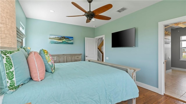 bedroom with ceiling fan and light wood-type flooring