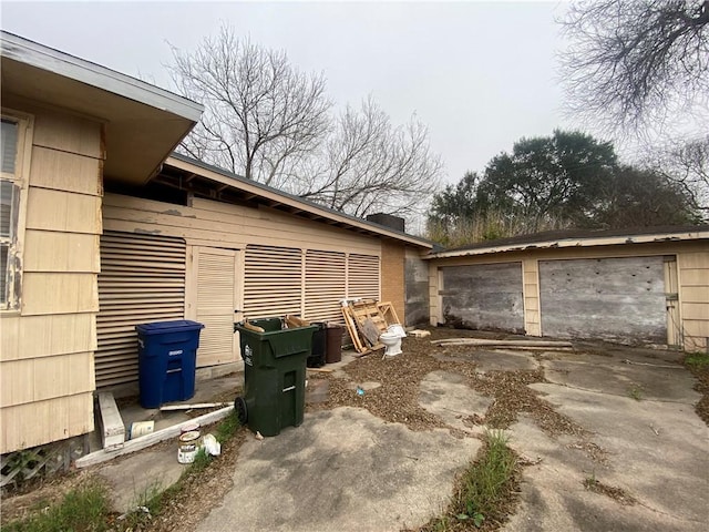 view of property exterior featuring an outbuilding and a garage