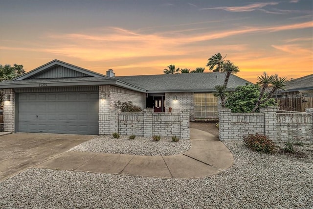 view of front of house with a garage, fence, roof with shingles, brick siding, and concrete driveway