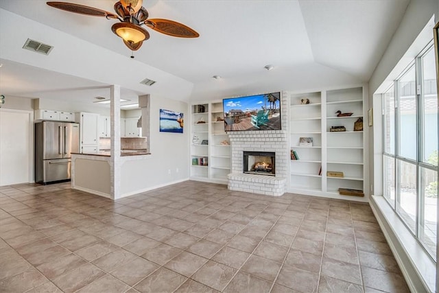 13810 Mizzen St, Corpus Christi, TX 78418 - unfurnished living room with built in features, ceiling fan, lofted ceiling, a fireplace, and light tile patterned floors