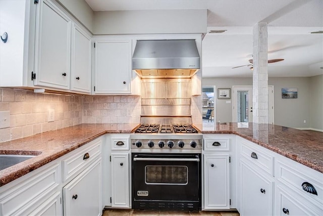 13810 Mizzen St, Corpus Christi, TX 78418 - kitchen featuring premium range, wall chimney range hood, stone counters, and decorative backsplash