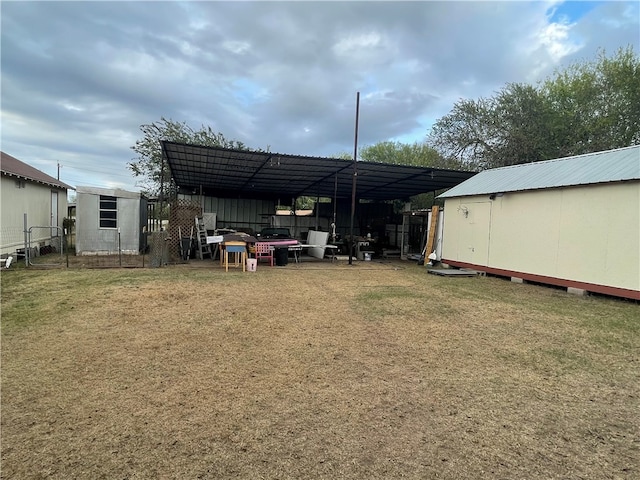 view of yard featuring a carport and an outdoor structure